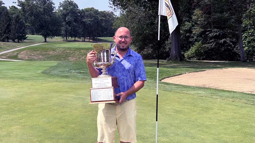 Vaughn Snyder holds the Cleveland Am trophy